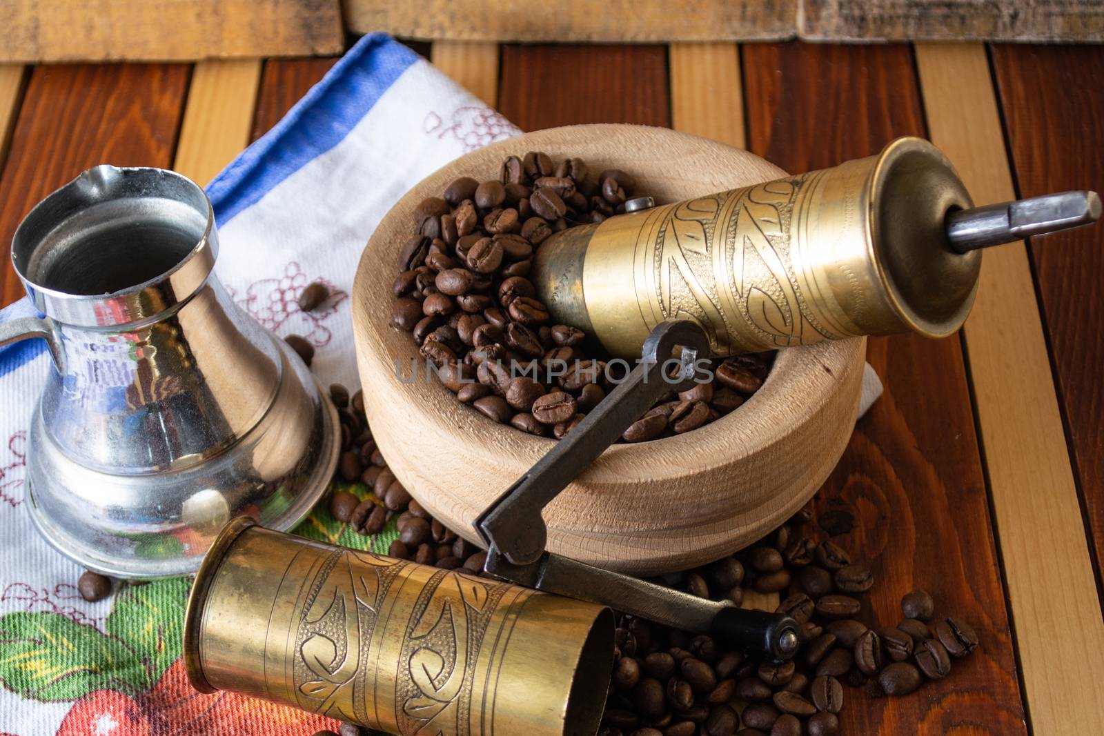 Coffee ready to be milled with old grinder. Coffee is in the table