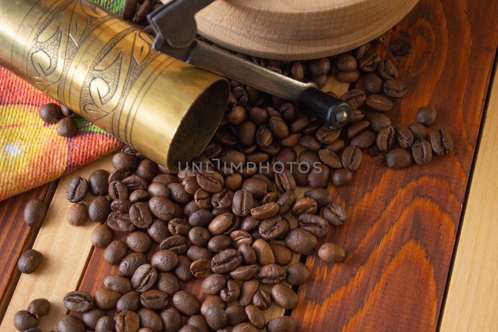 Coffee ready to be milled with old grinder. Coffee is in the table