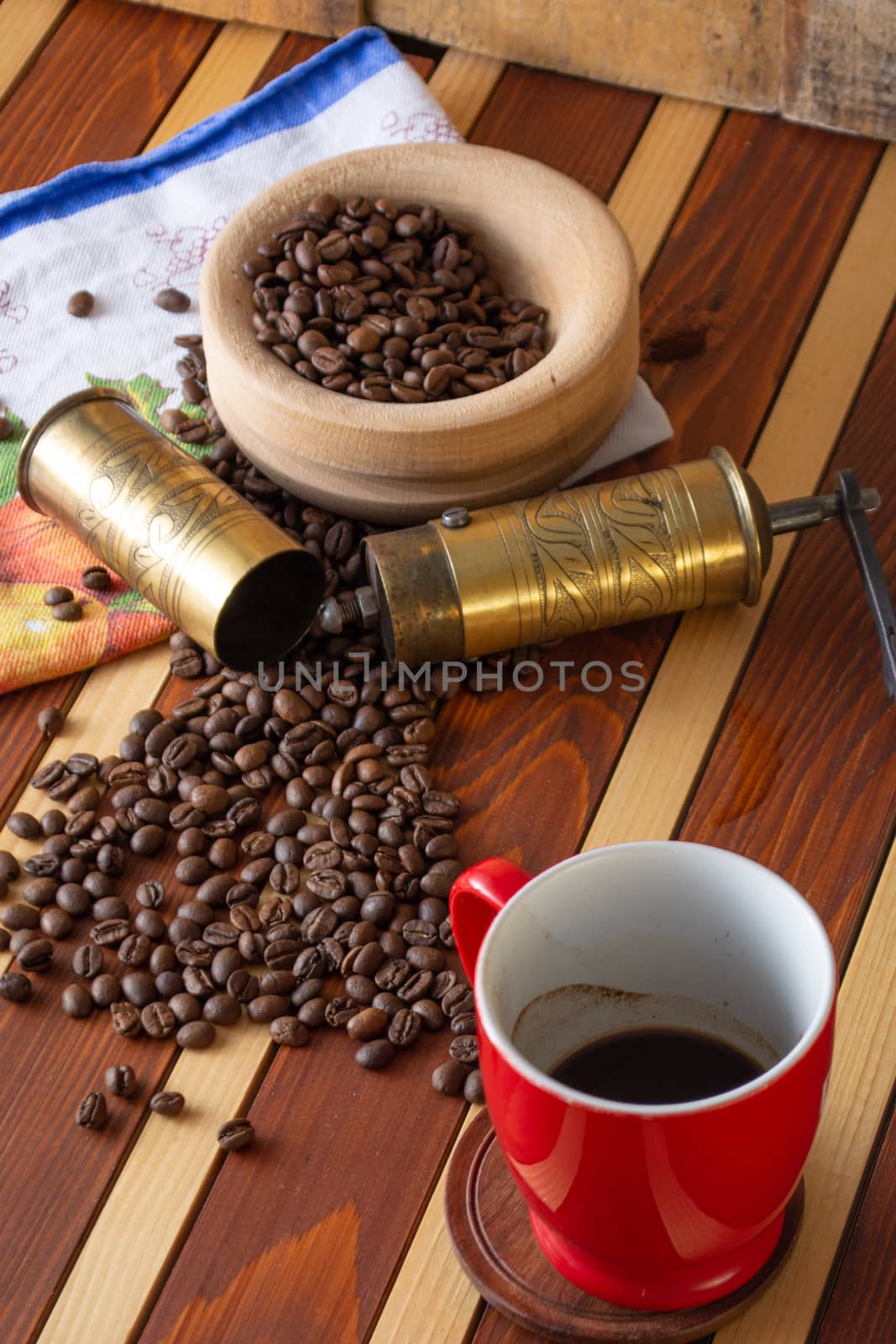 Coffee ready to be milled with old grinder. Coffee is in the table