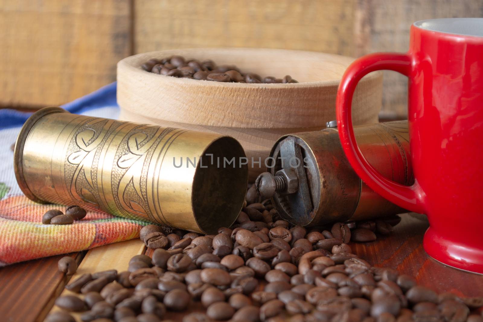 Coffee ready to be milled with old grinder. Coffee is in the table