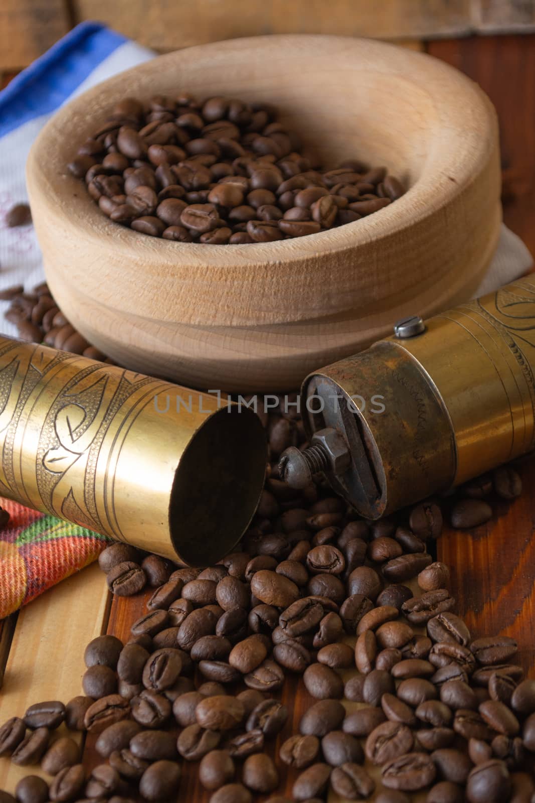 Coffee ready to be milled with old grinder. Coffee is in the table