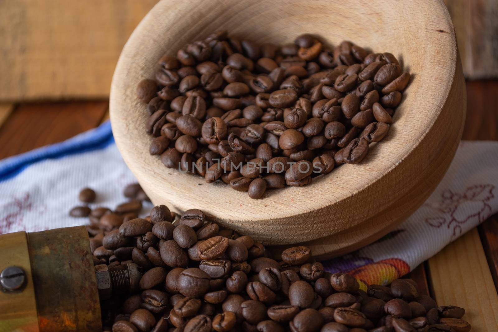 Coffee ready to be milled with old grinder. Coffee is in the table