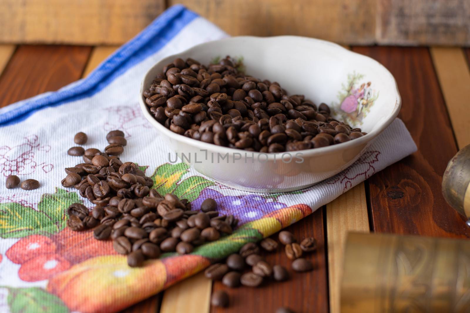 Coffee ready to be milled with old grinder. Coffee is in the table