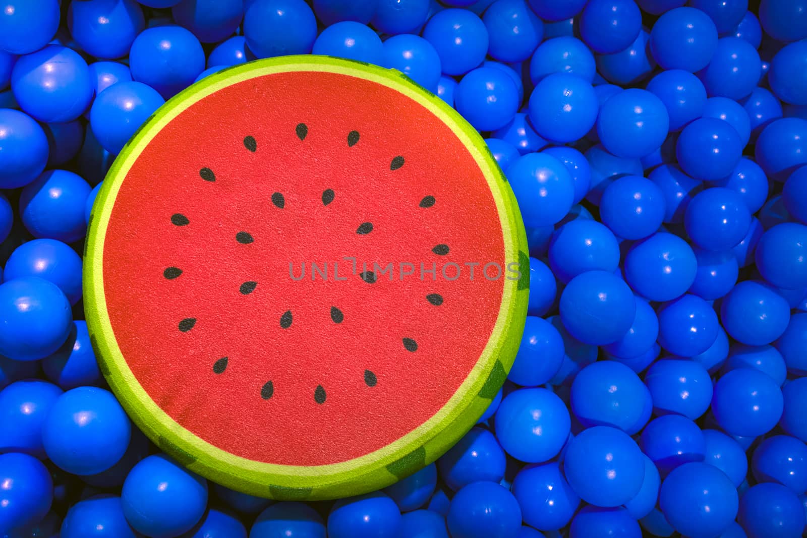 Watermelon Slice Shaped Cusion Floating on a Sea of balls