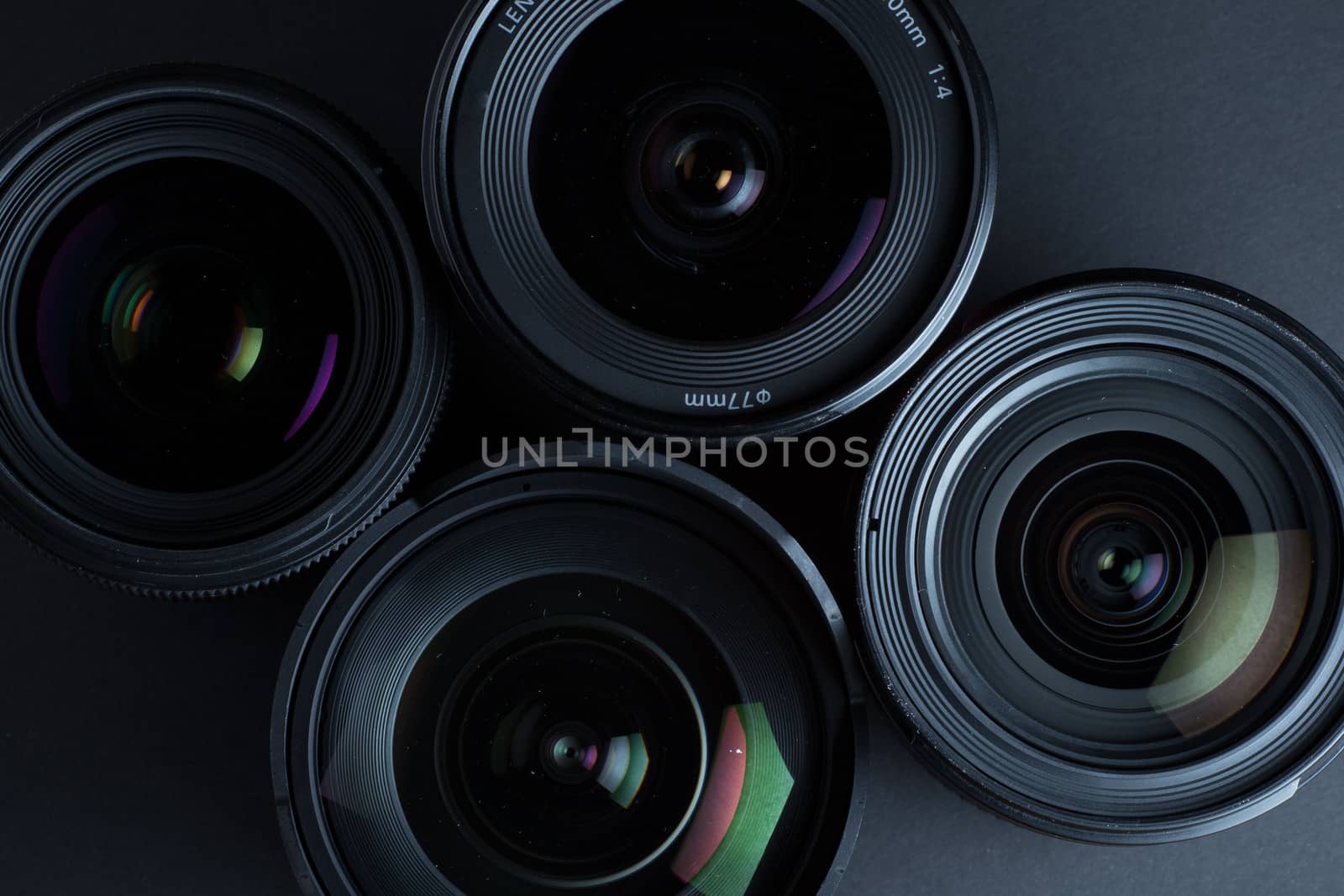 Set of various DSLR lenses with colorful reflections - shot from above