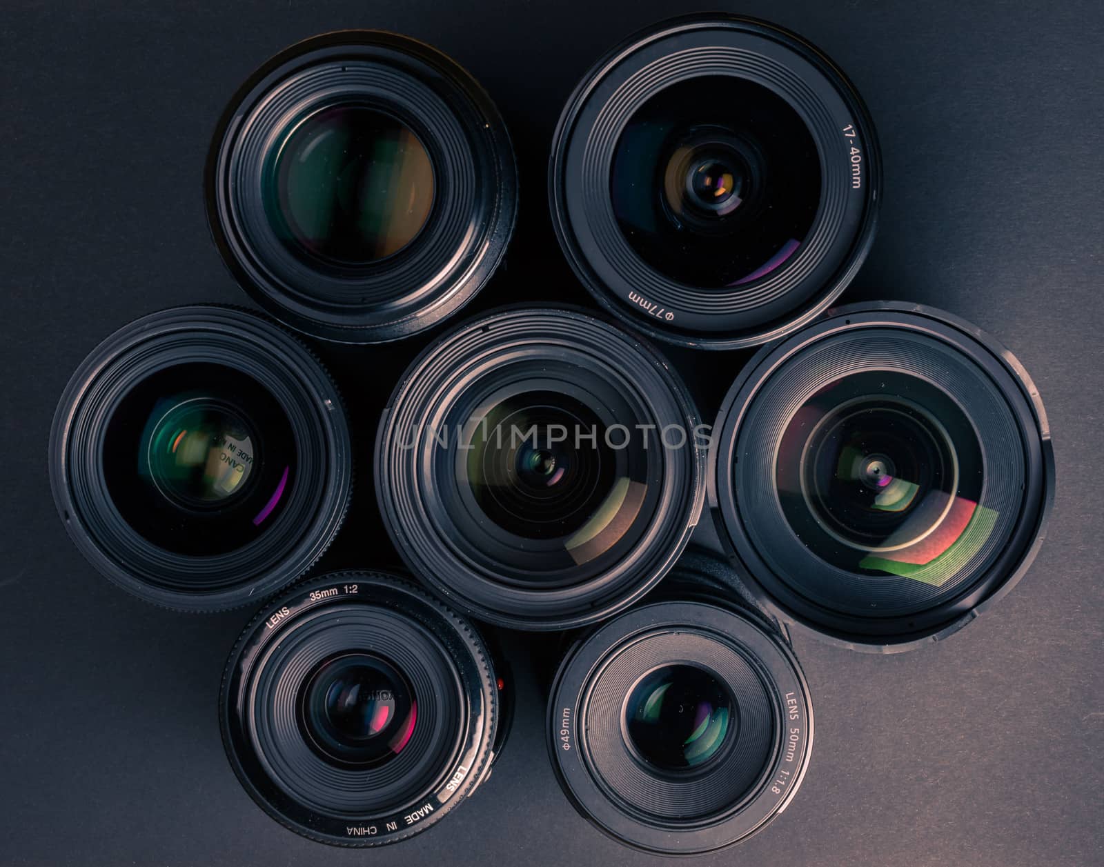 Set of various DSLR lenses with colorful reflections - shot from above