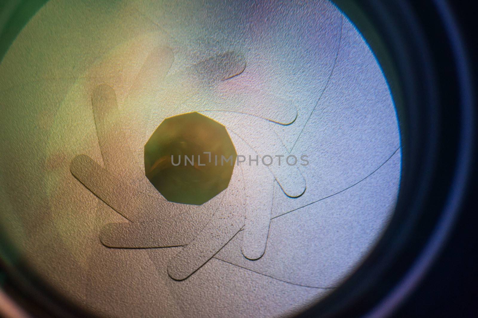 Camera lens aperture detail withl colorful lens reflections - macro photo