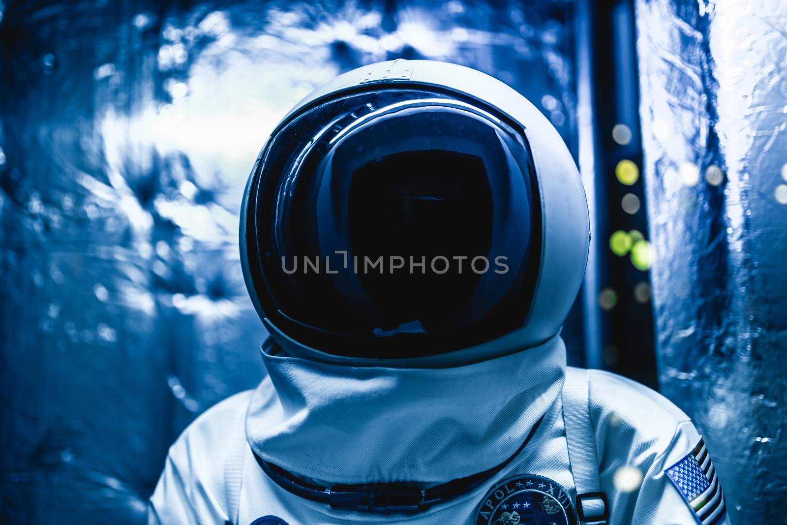 Cosmonaut in a space suit inside space ship