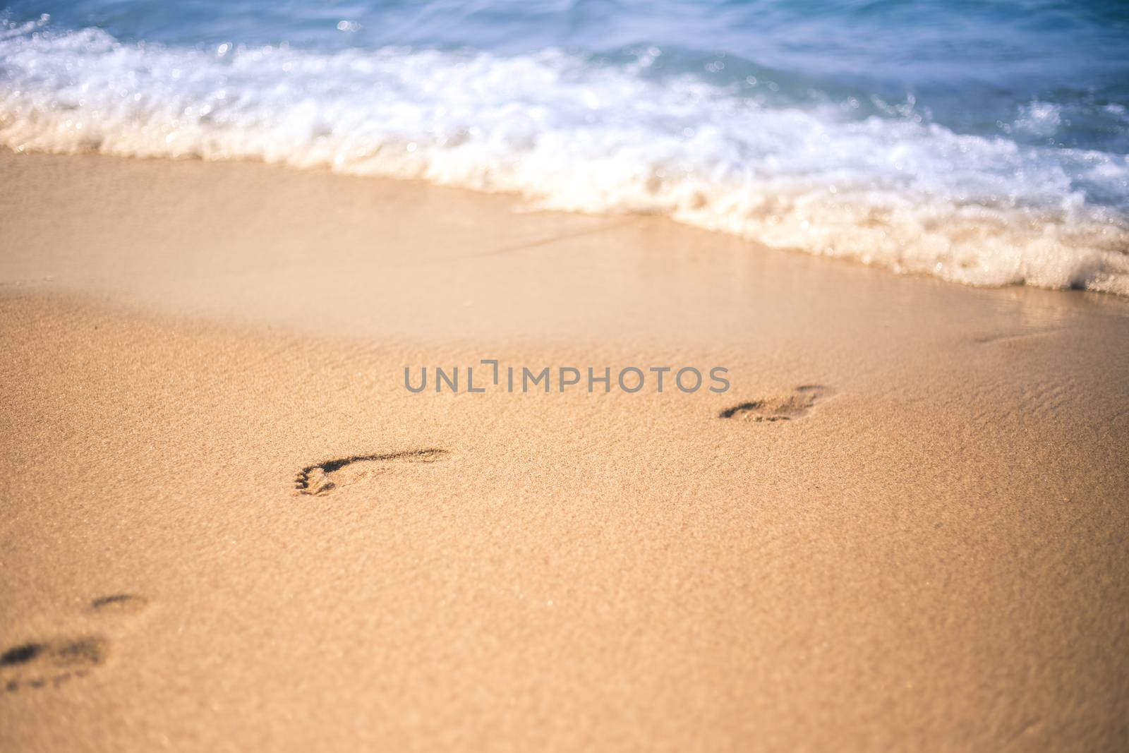 Footprint in a beach sand from sea in a summer.