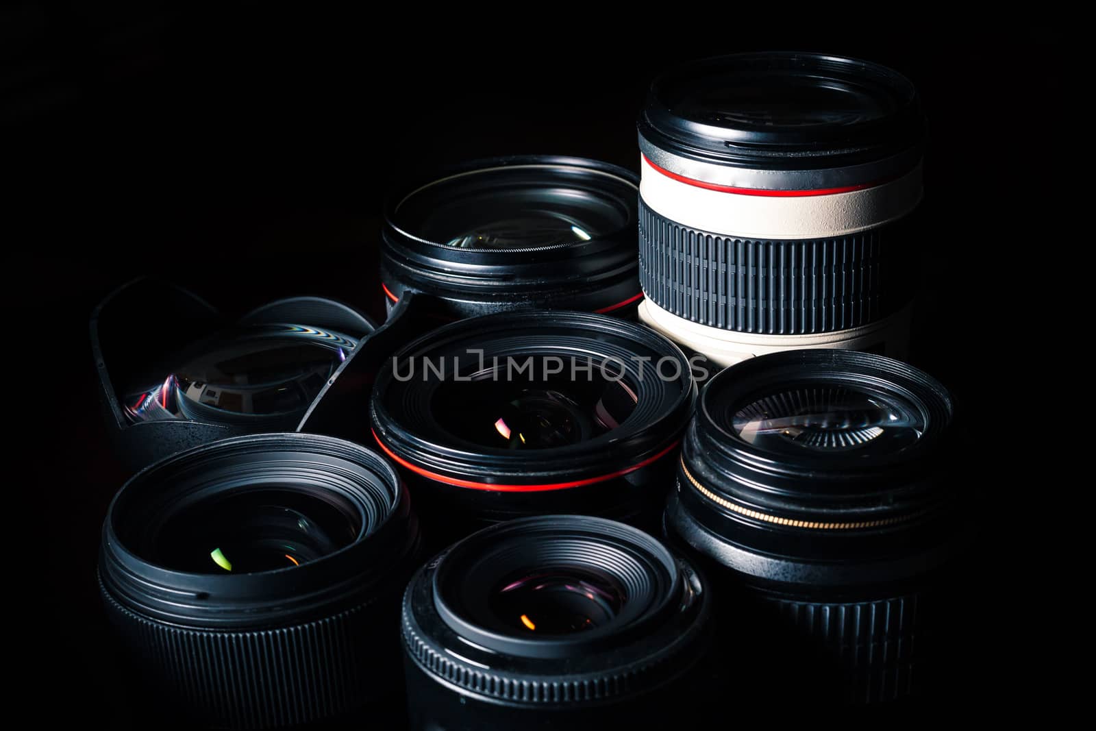 Set of different DSLR lenses on a dark background - dramatic lighting