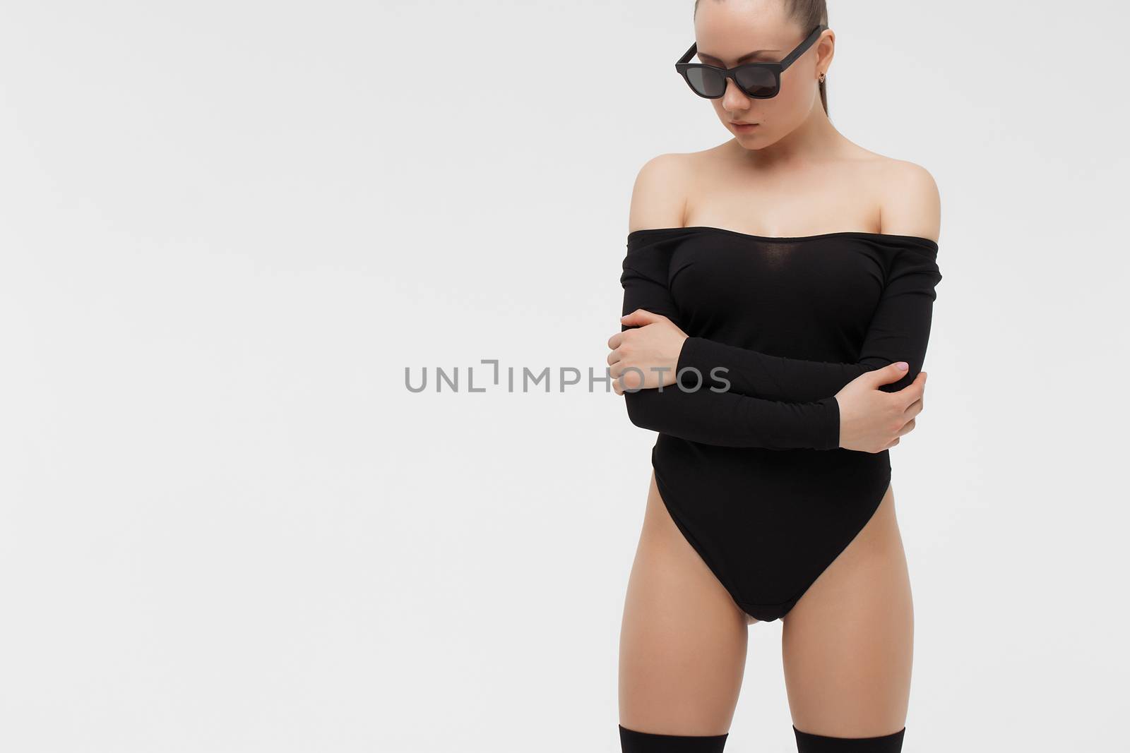 Crop view of attractive erotic young woman in lingerie crossing hands