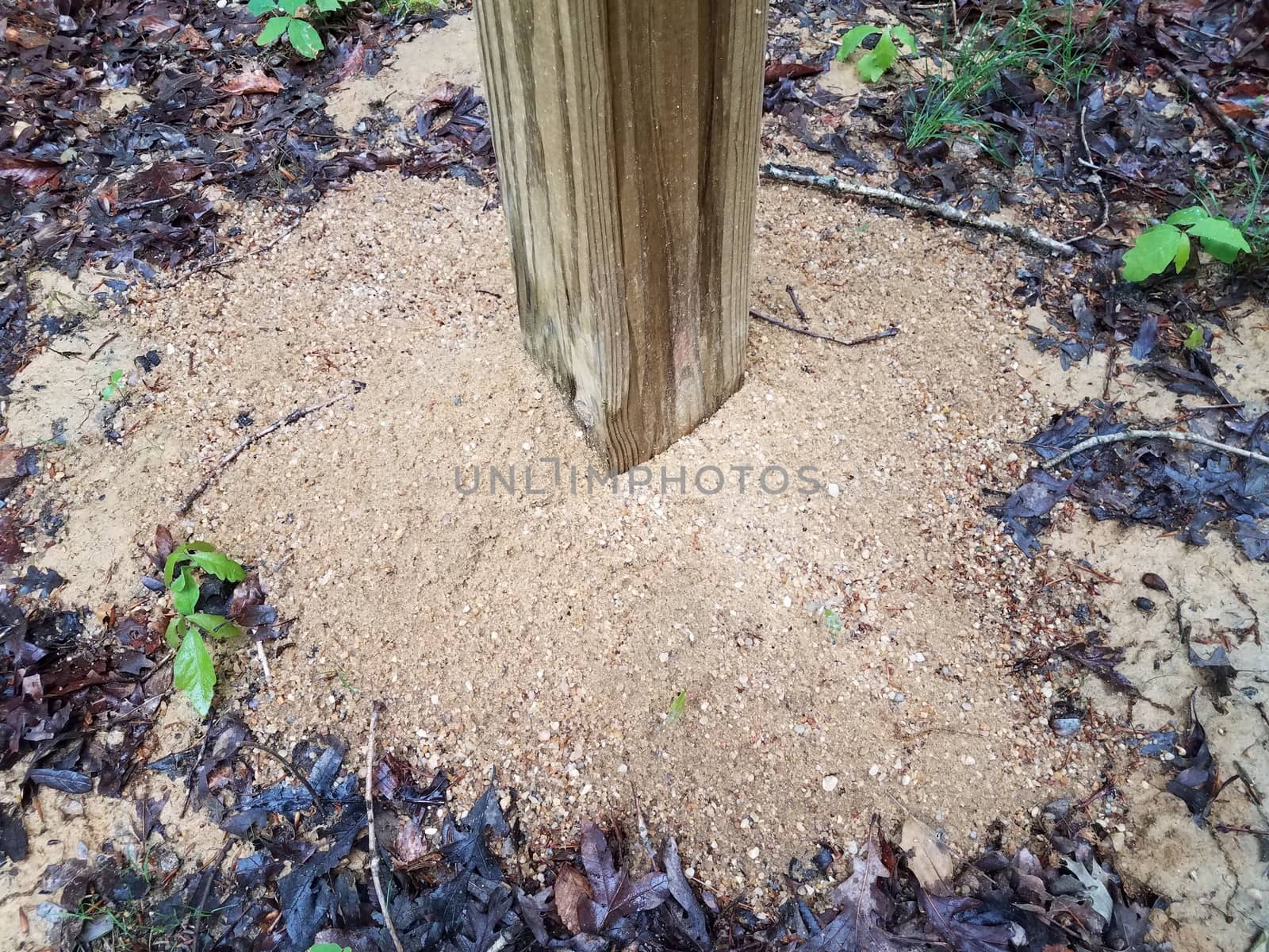 wood pole and wet soil or sand on ground by stockphotofan1