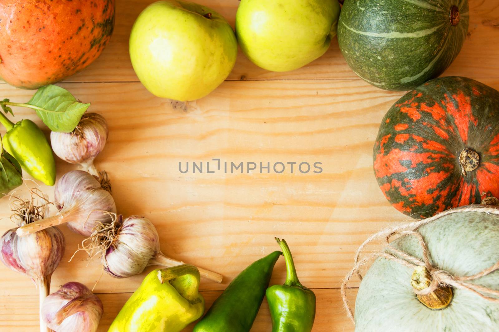 Harvest or Thanksgiving background with autumn fruits and gourds on a rustic wooden table by claire_lucia