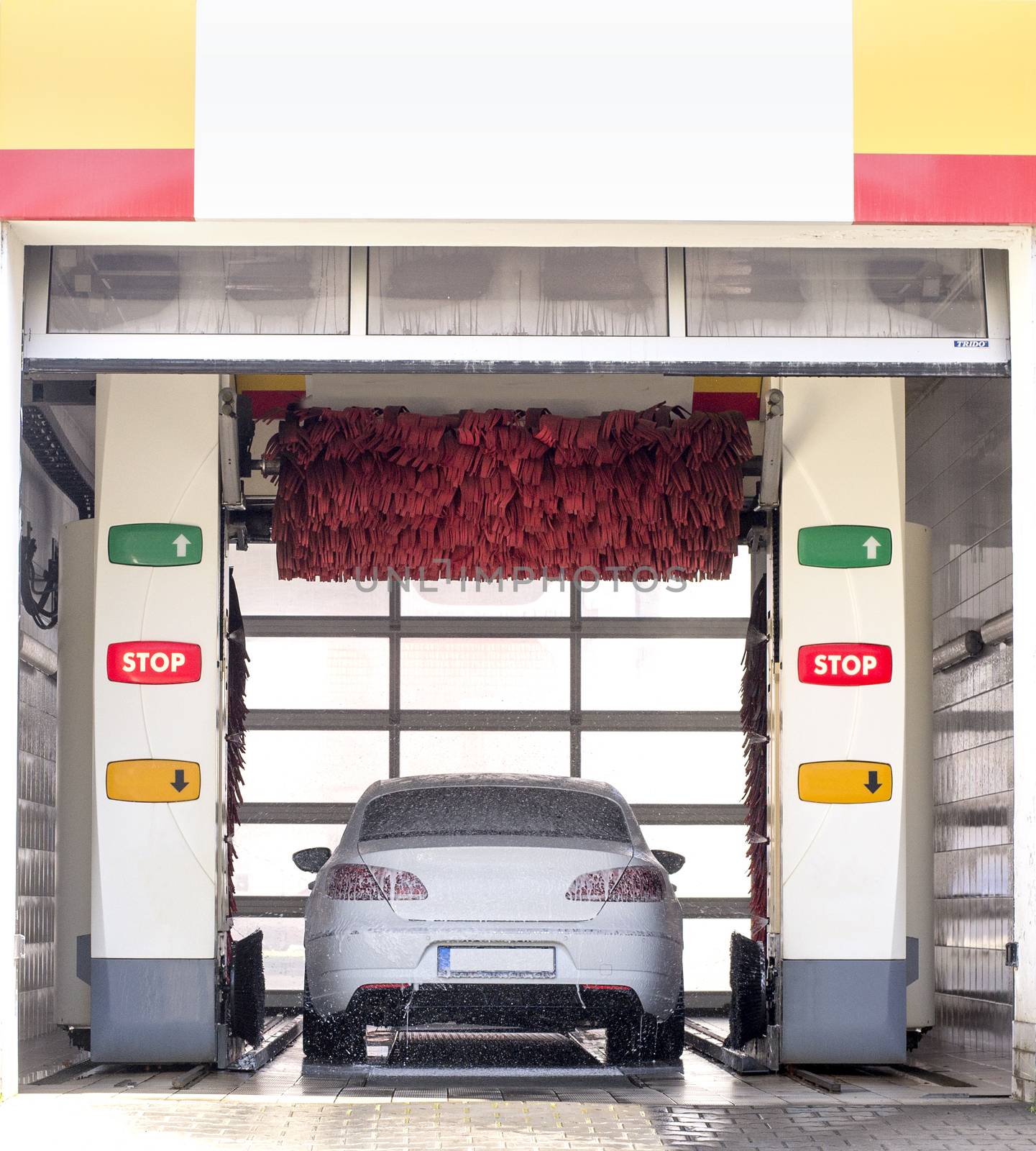 White european car in automatic car wash machine