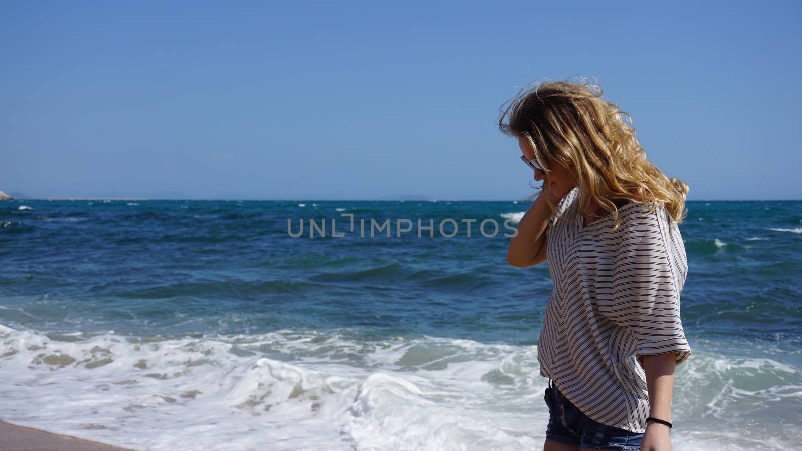 Beautiful bohemian styled and tanned girl at the sea beach in sunlight
