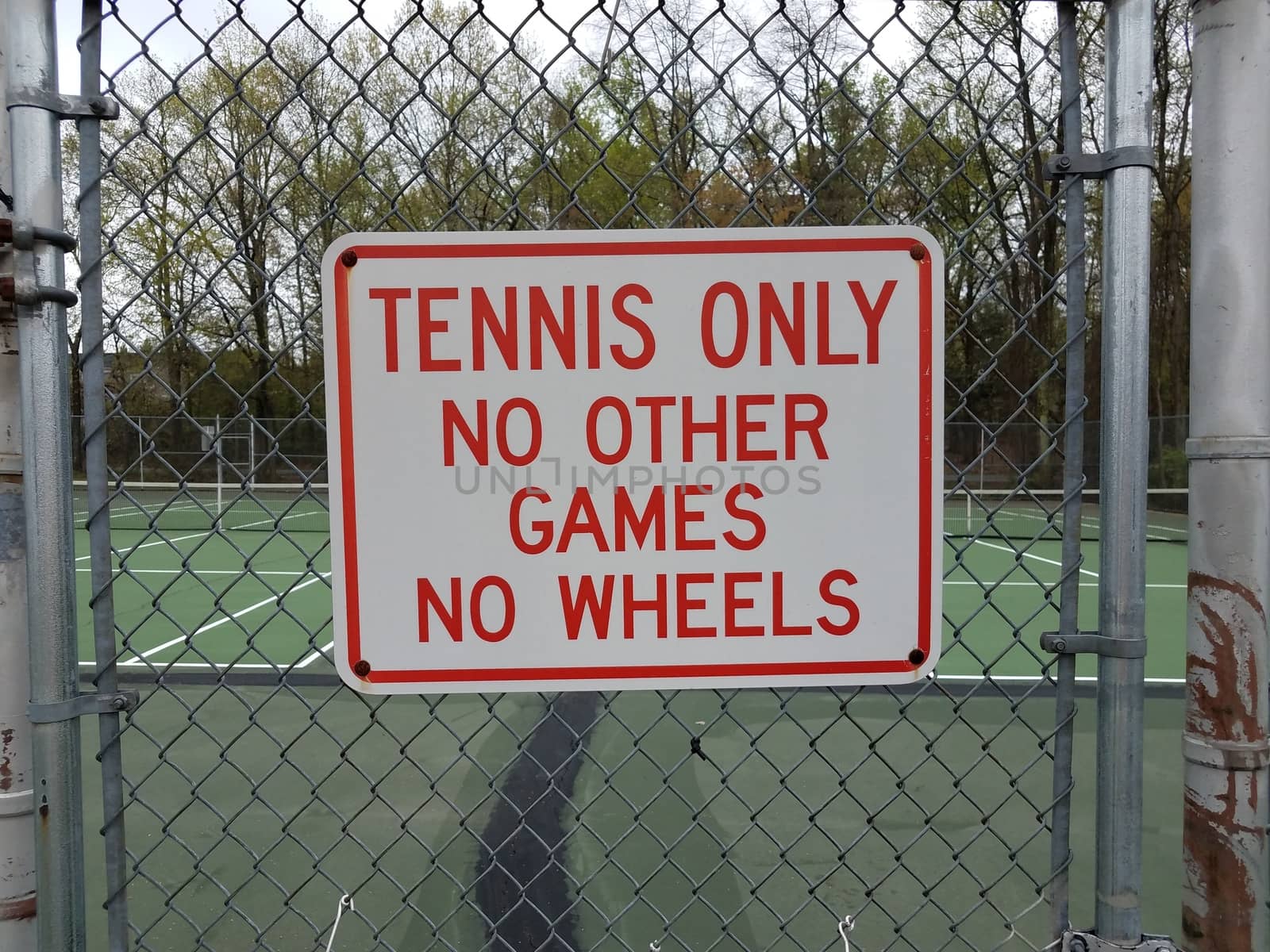 tennis only no other games no wheels sign on metal fence at tennis court by stockphotofan1