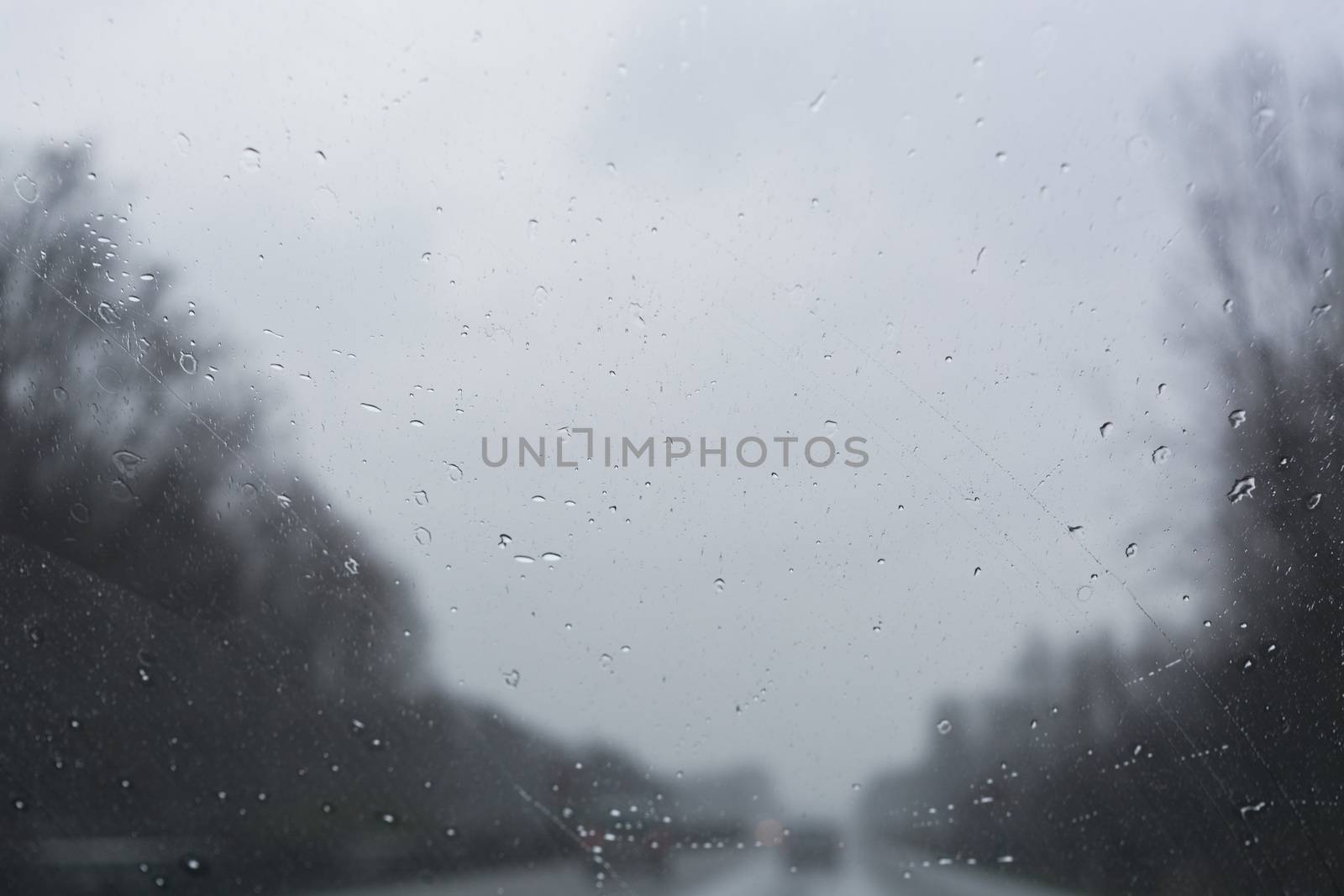 Traffic jam on rainy bad day, raindrops on car window