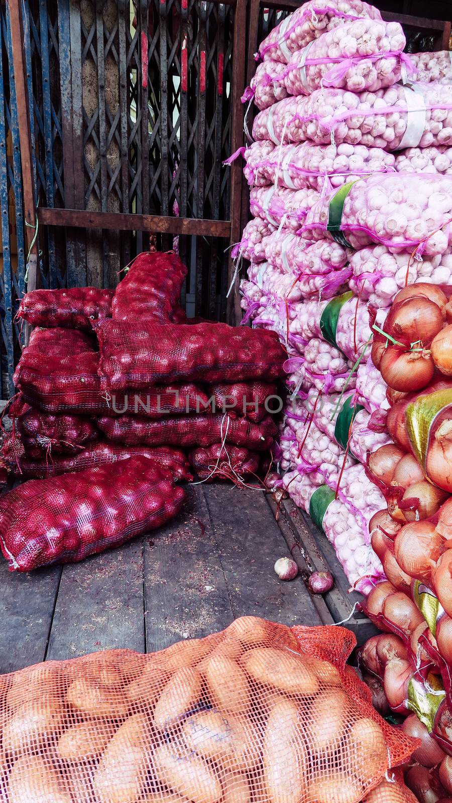 Stack of garlic and Shallot in market by ponsulak