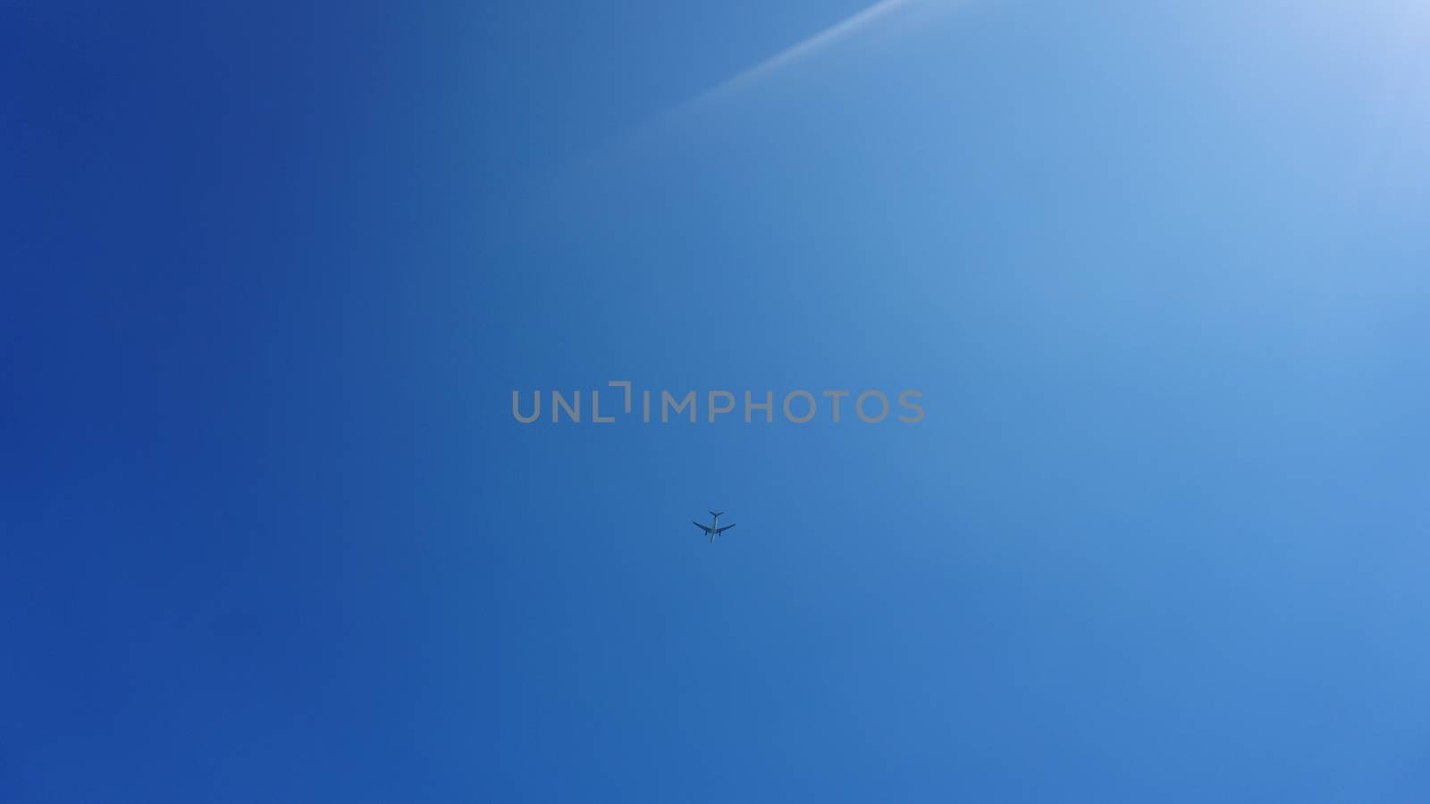 Airplane frying in the blue sky by natali_brill
