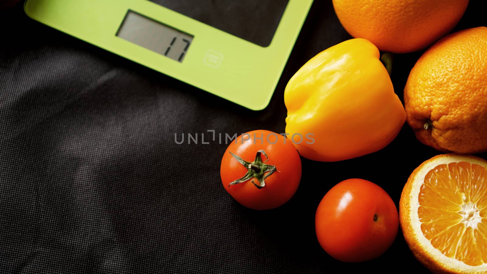 Concept diet. Healthy food, kitchen weight scale. Vegetables and fruits. Top view close-up on black background