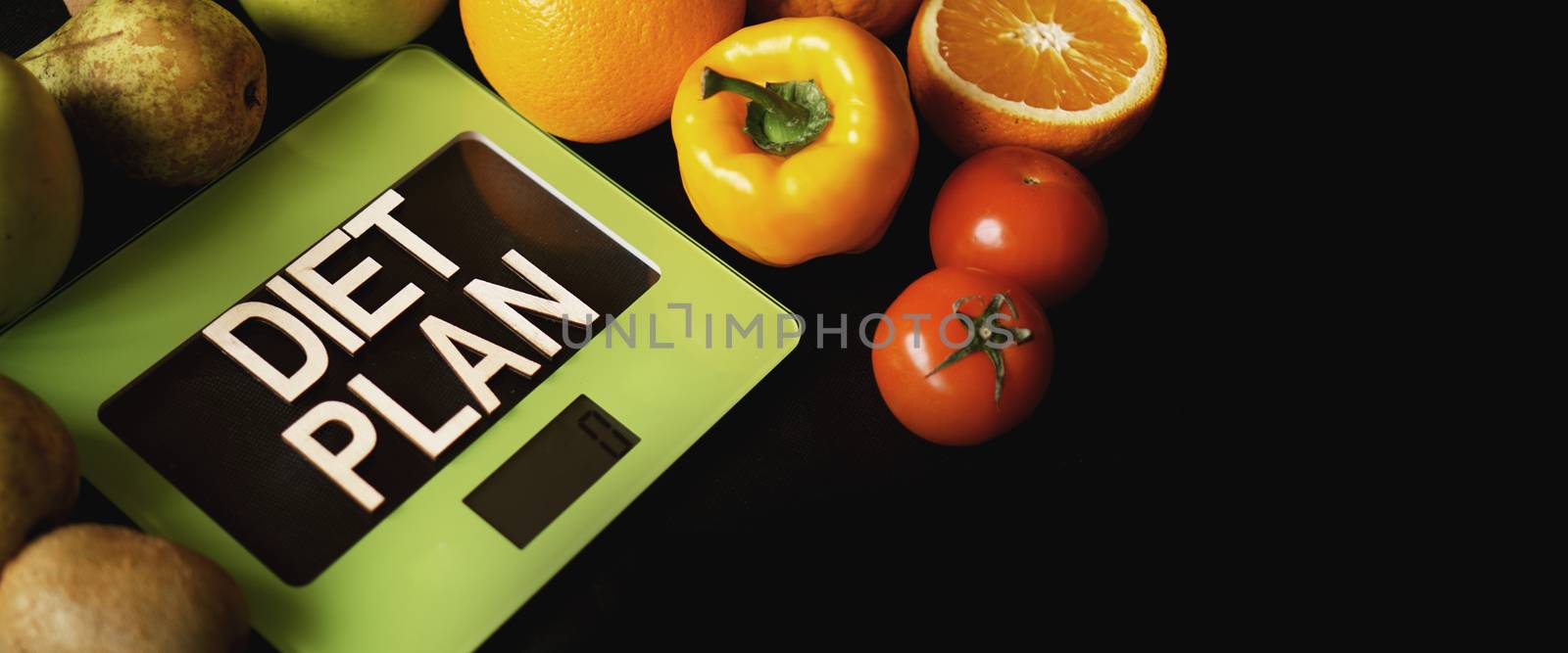 Concept diet. Healthy food, kitchen weight scale. Vegetables and fruits lettering Diet plan on black background