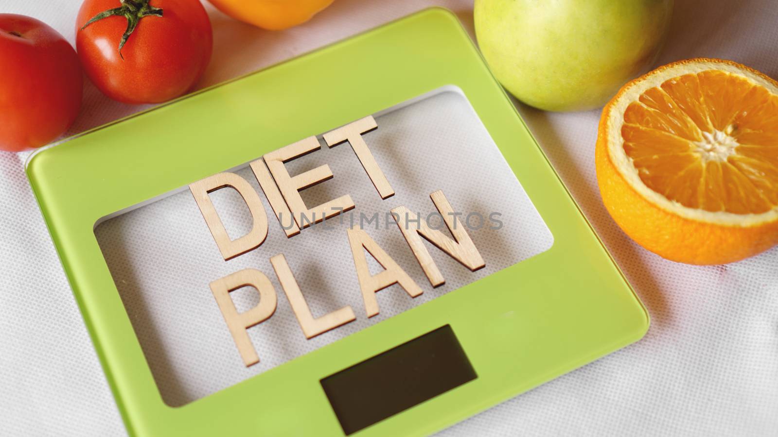Concept diet. Healthy food, kitchen weight scale. Vegetables and fruits lettering Diet plan