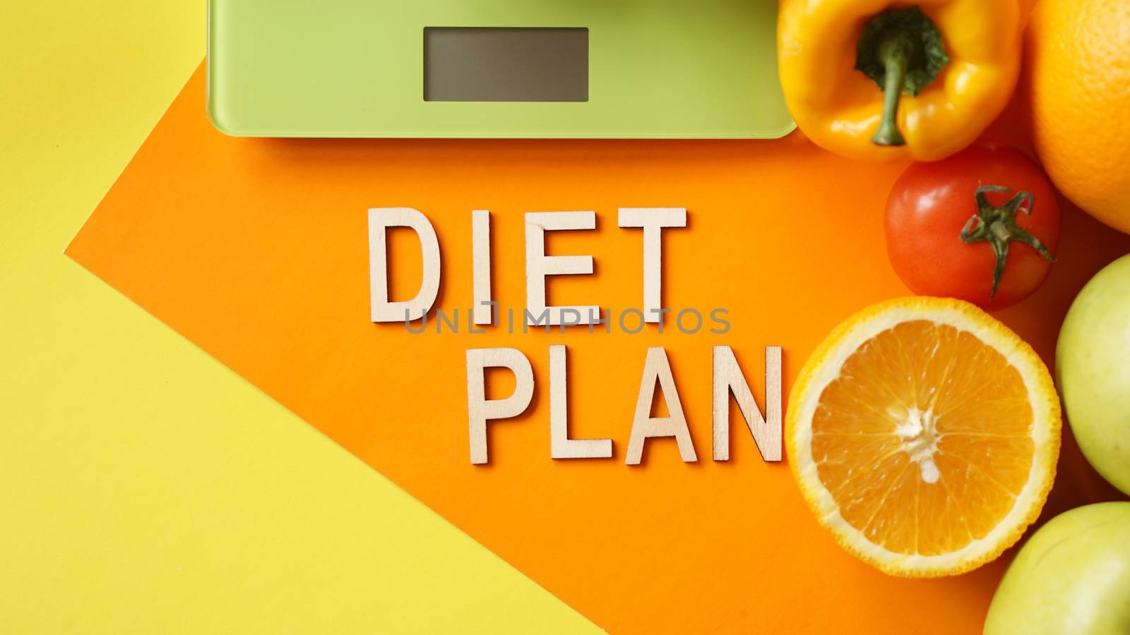 Concept diet. Healthy food, kitchen weight scale. Vegetables and fruits lettering Diet plan on orange background