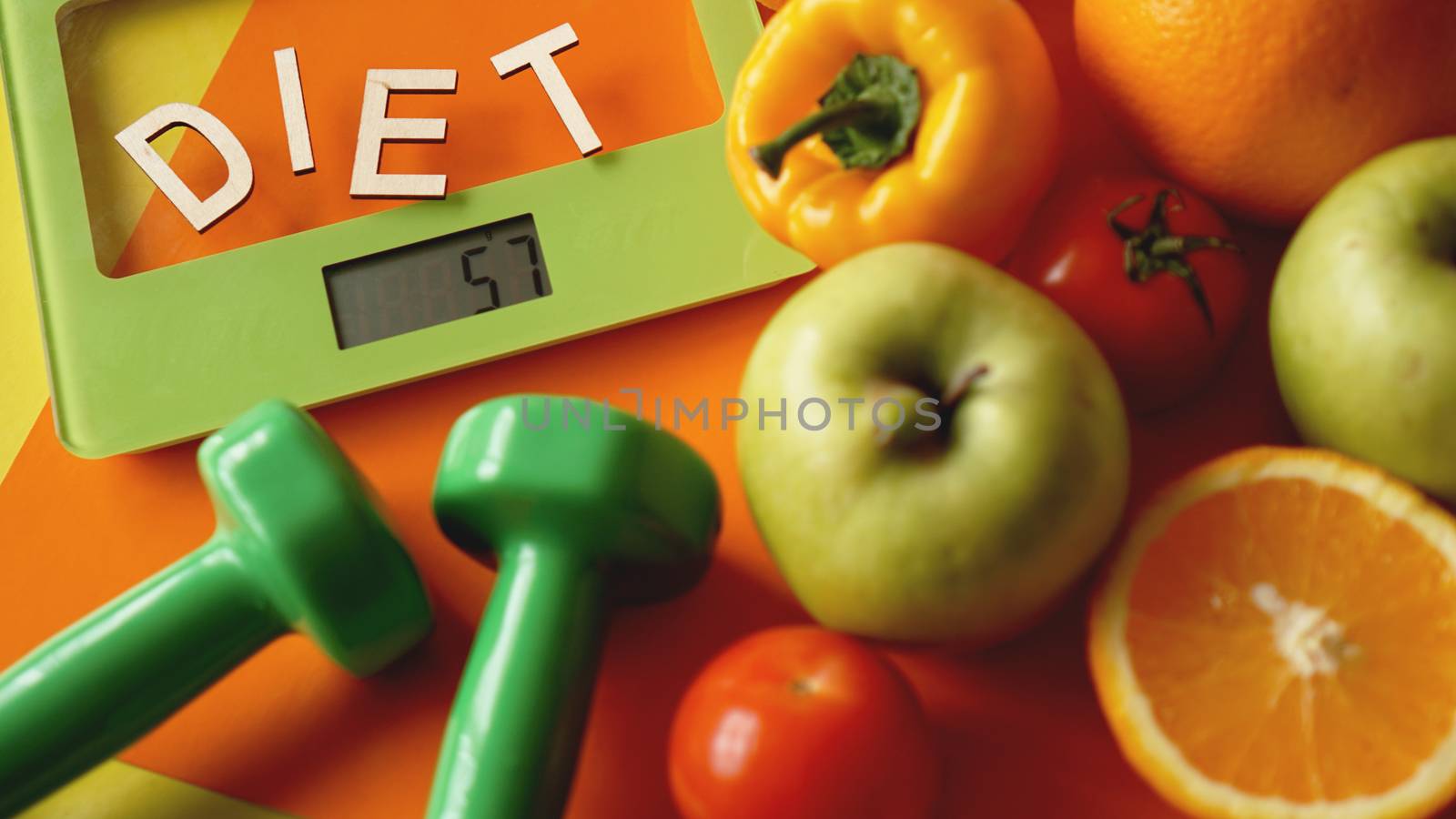 Concept diet. Healthy food, kitchen weight scale. Vegetables and fruits. Top view close-up on orange background