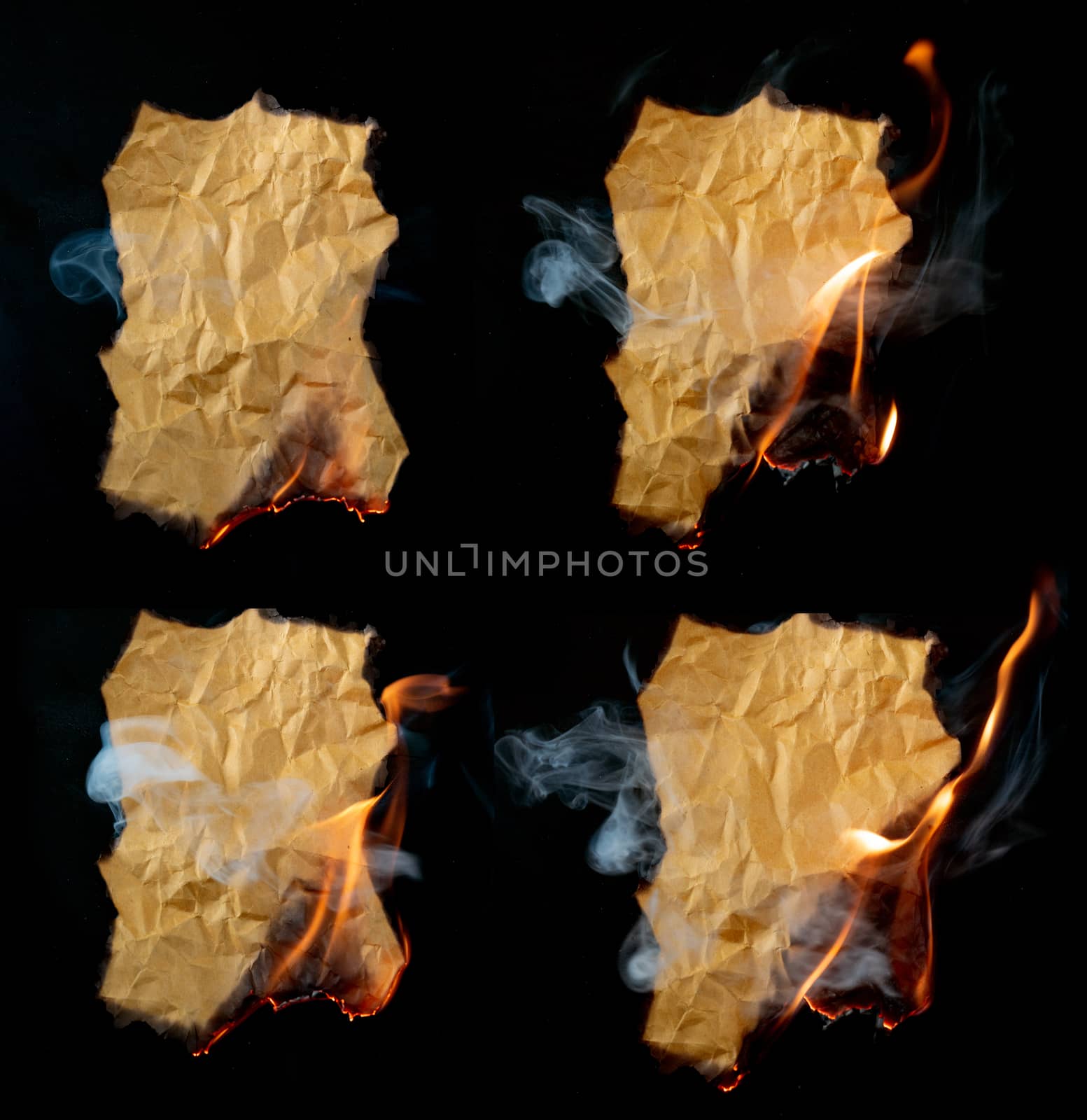 burning piece of crumpled paper on black background