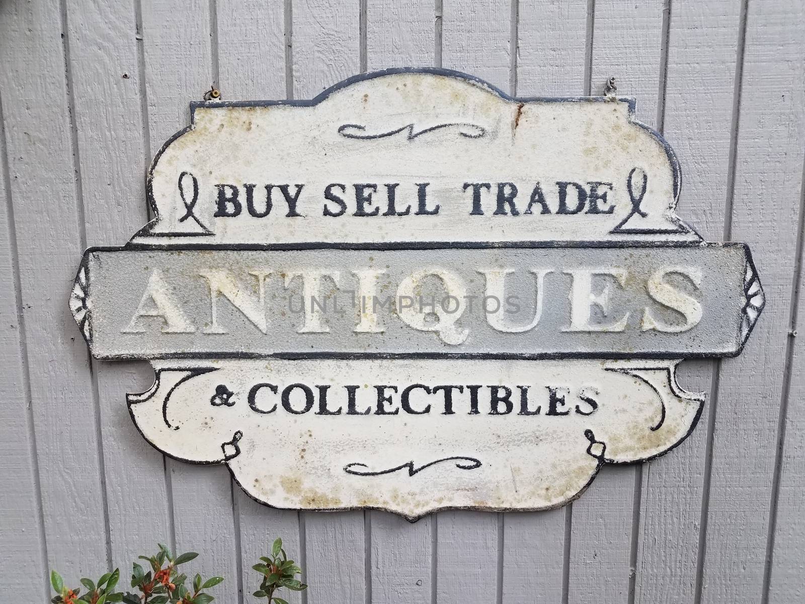 old buy sell trade antiques collectibles sign on grey wall