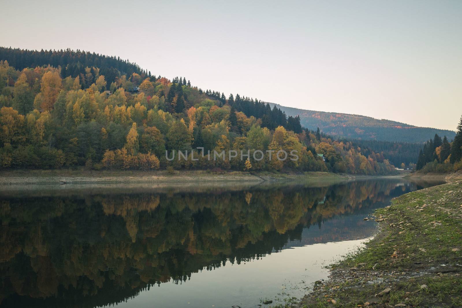 Dark colorful autumn mountain lake in the evening, calm scene