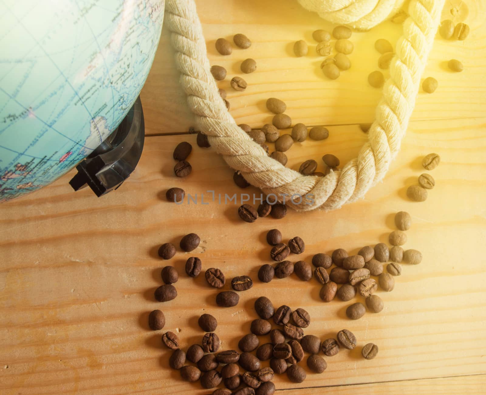 Happy OPENING day of Columbus. A globe, a rope, coffee beans on a wooden Board, SOLAR LIGHT.