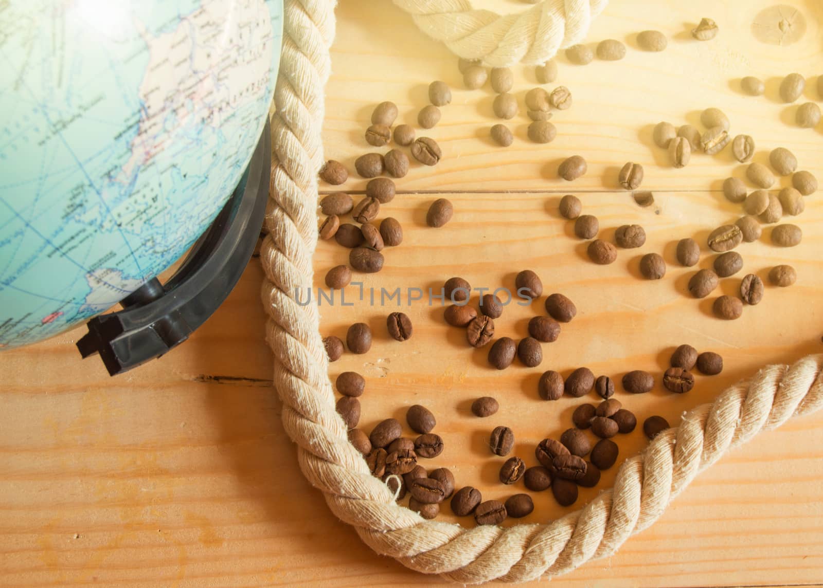 Happy OPENING day of Columbus. A globe, a rope, coffee beans on a wooden Board, SOLAR LIGHT.