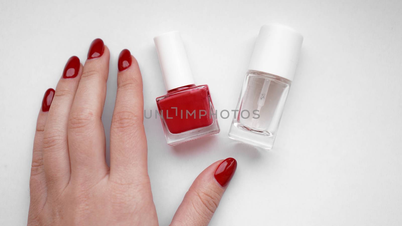 Beautiful female hands. Hand skin care. Beautiful Woman Hands With Red Manicure. Red nail polish and Cuticle oil.
