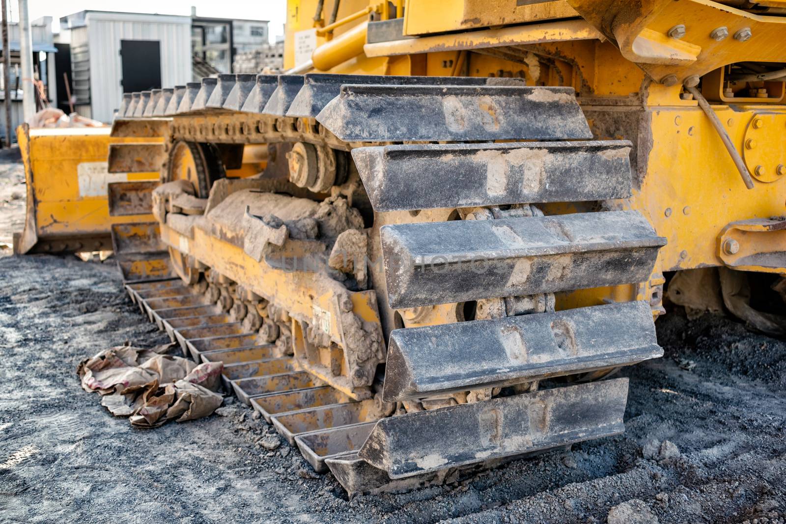 Metal Tracks on a Bulldozer on Construction Site. by seika_chujo