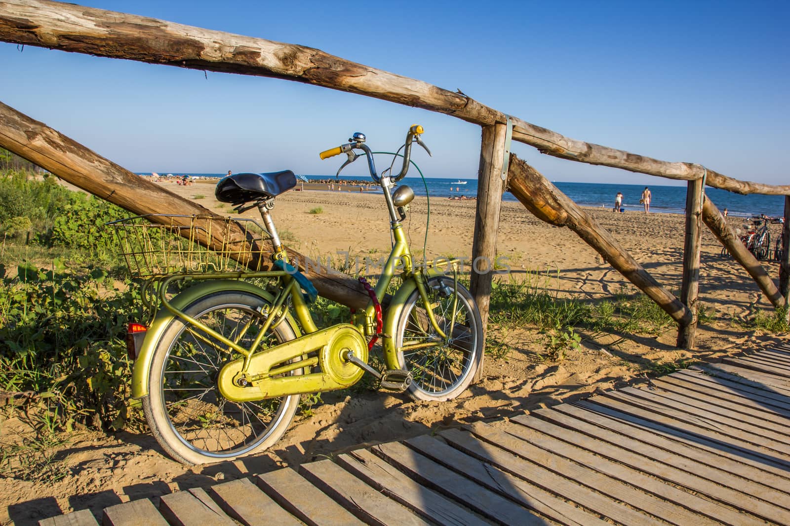 Nice retro vintage bicycle near beach on wooden road, sunny day