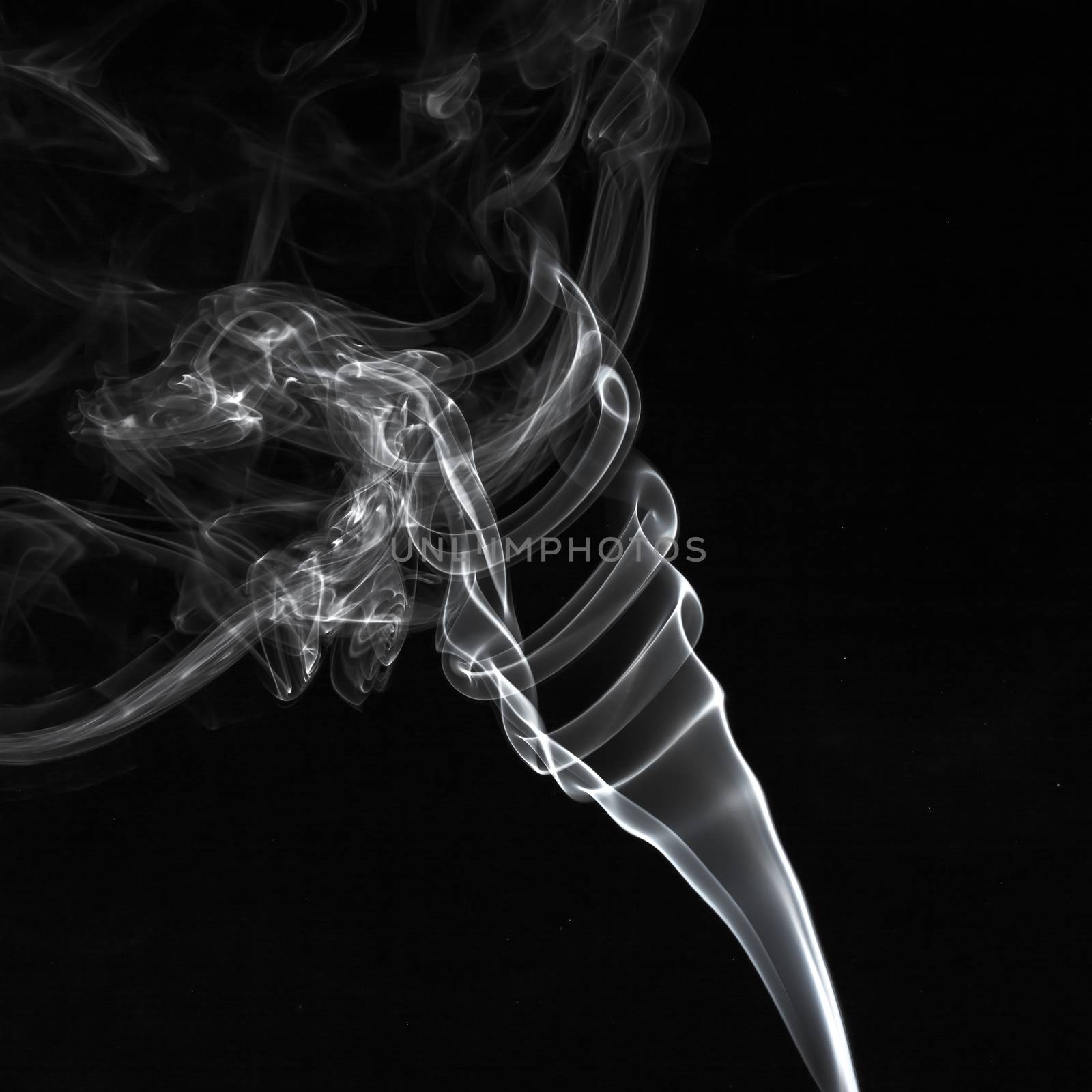 Abstract white smoke swirls over the black background