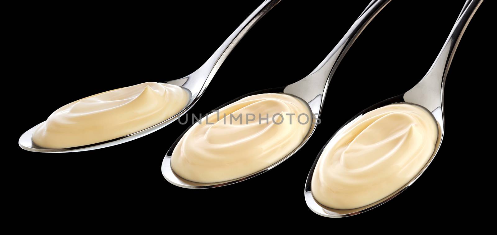 Sour cream in spoon isolated on black background. Collection