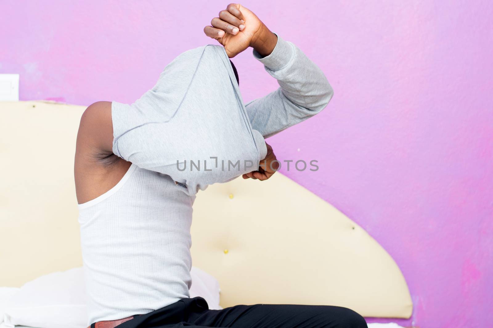 This young man just arrived from work undressed to take a bath.