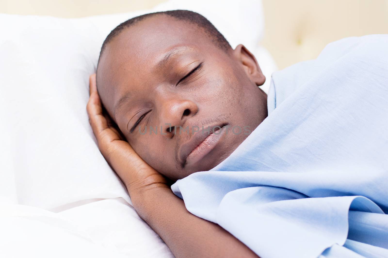 this young man asleep and enjoying the comfort of the bed