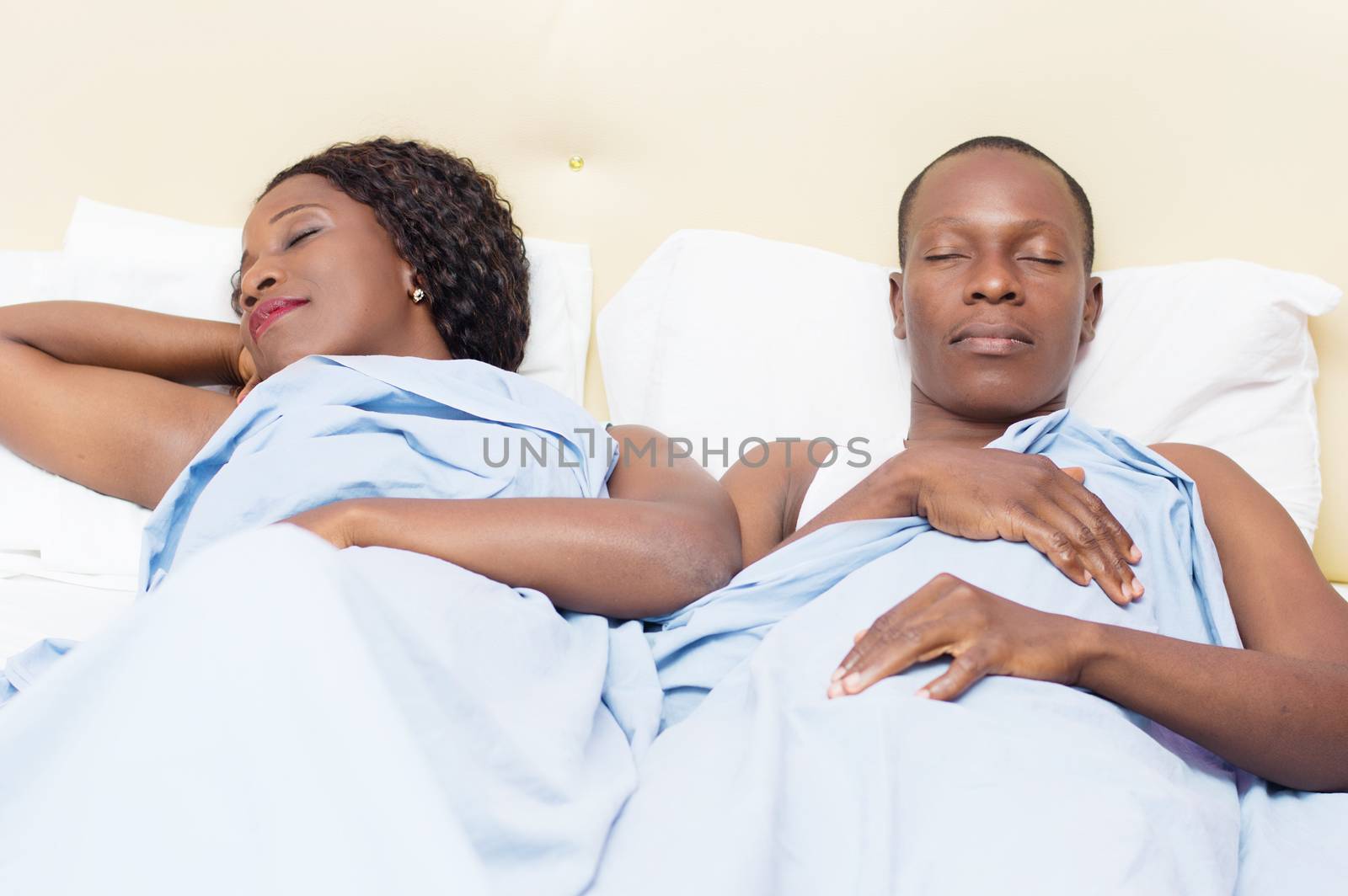 tired young couples sleep deeply in their bed