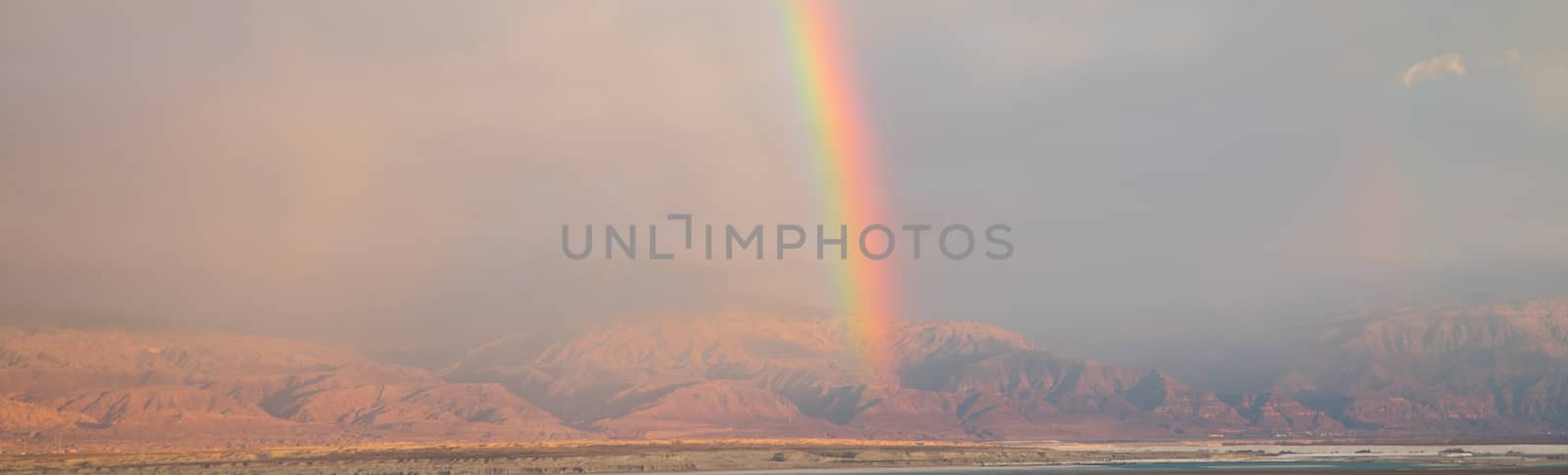 rainbow over the dead sea with jordan as background, view from masada
