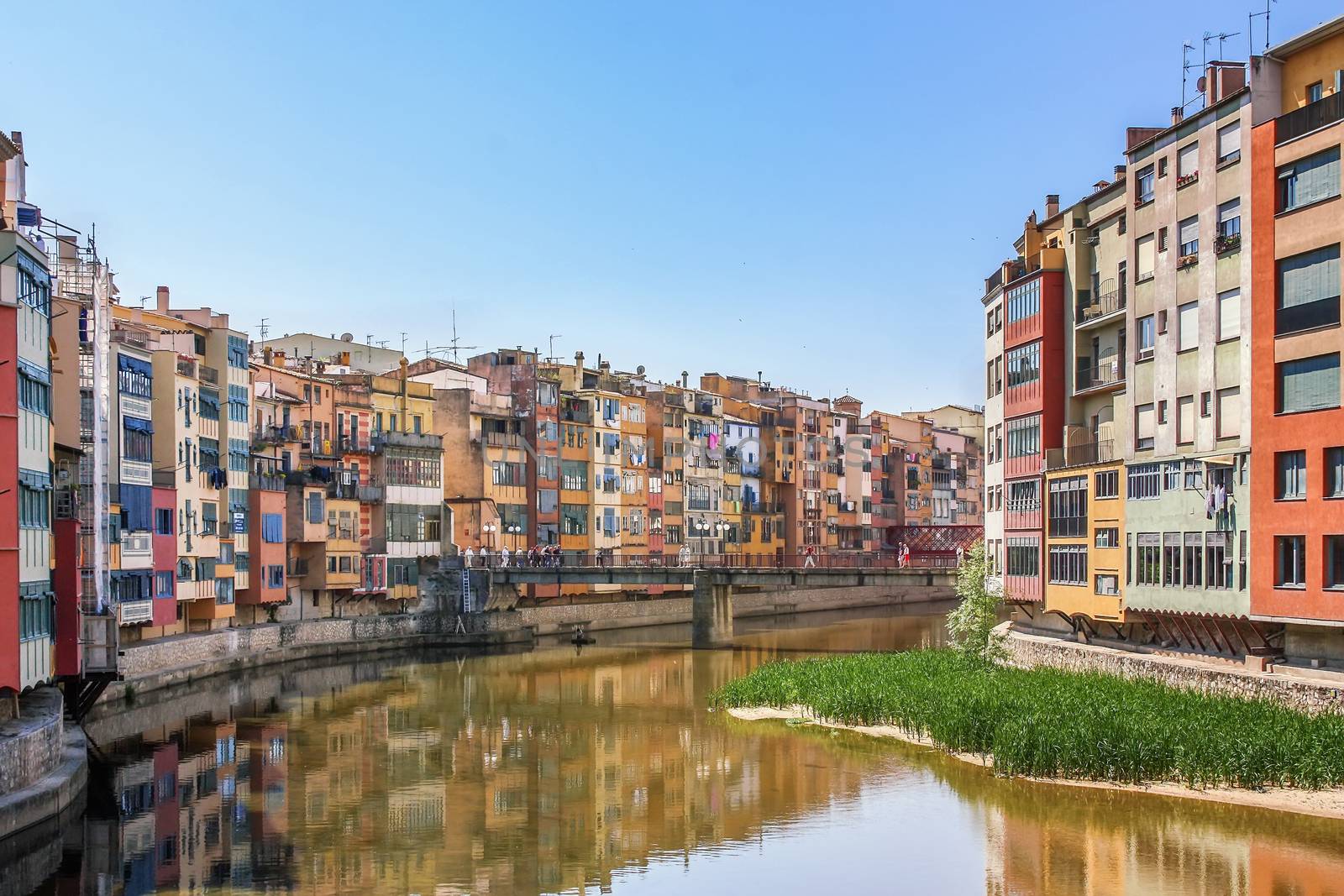 Painted houses crowded along the bank of the Riu Onyar in Girona, Spain