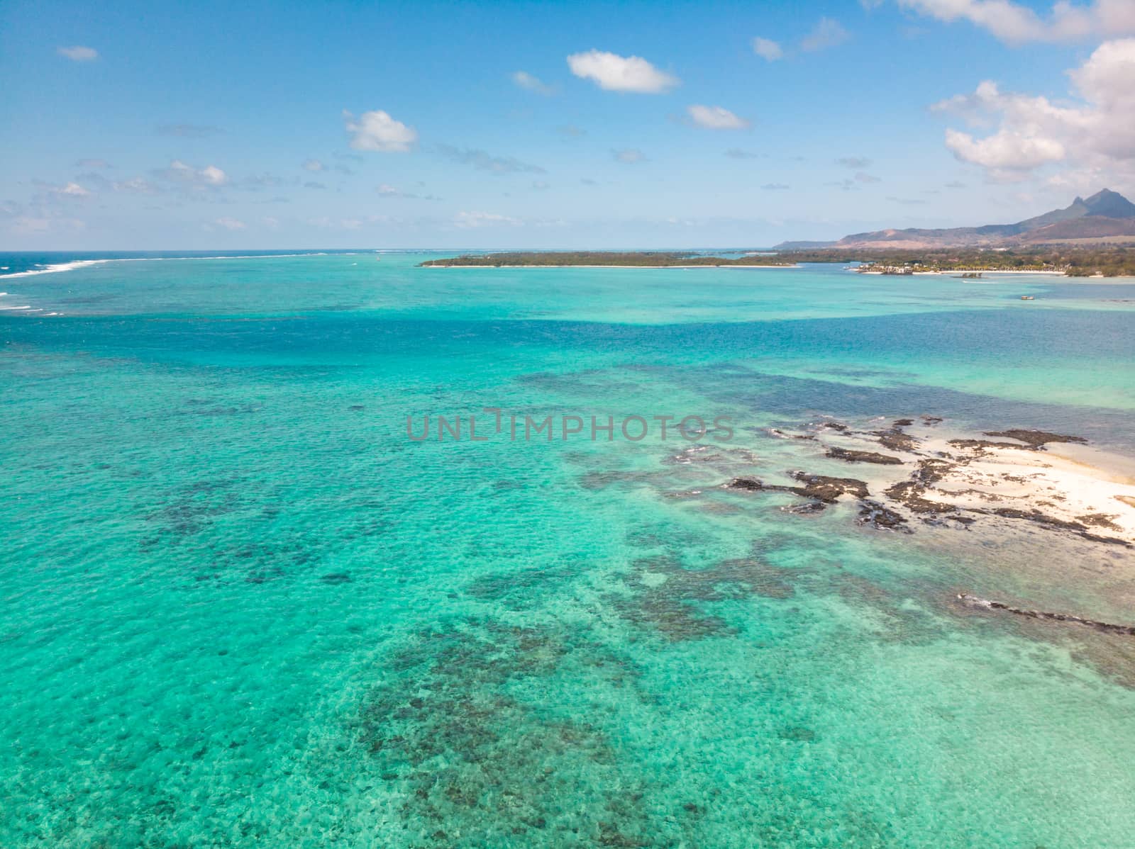 Aerial view of beautiful tropical beach with turquoise sea. Tropical vacation paradise destination of D'eau Douce and Ile aux Cerfs Mauritius by kasto