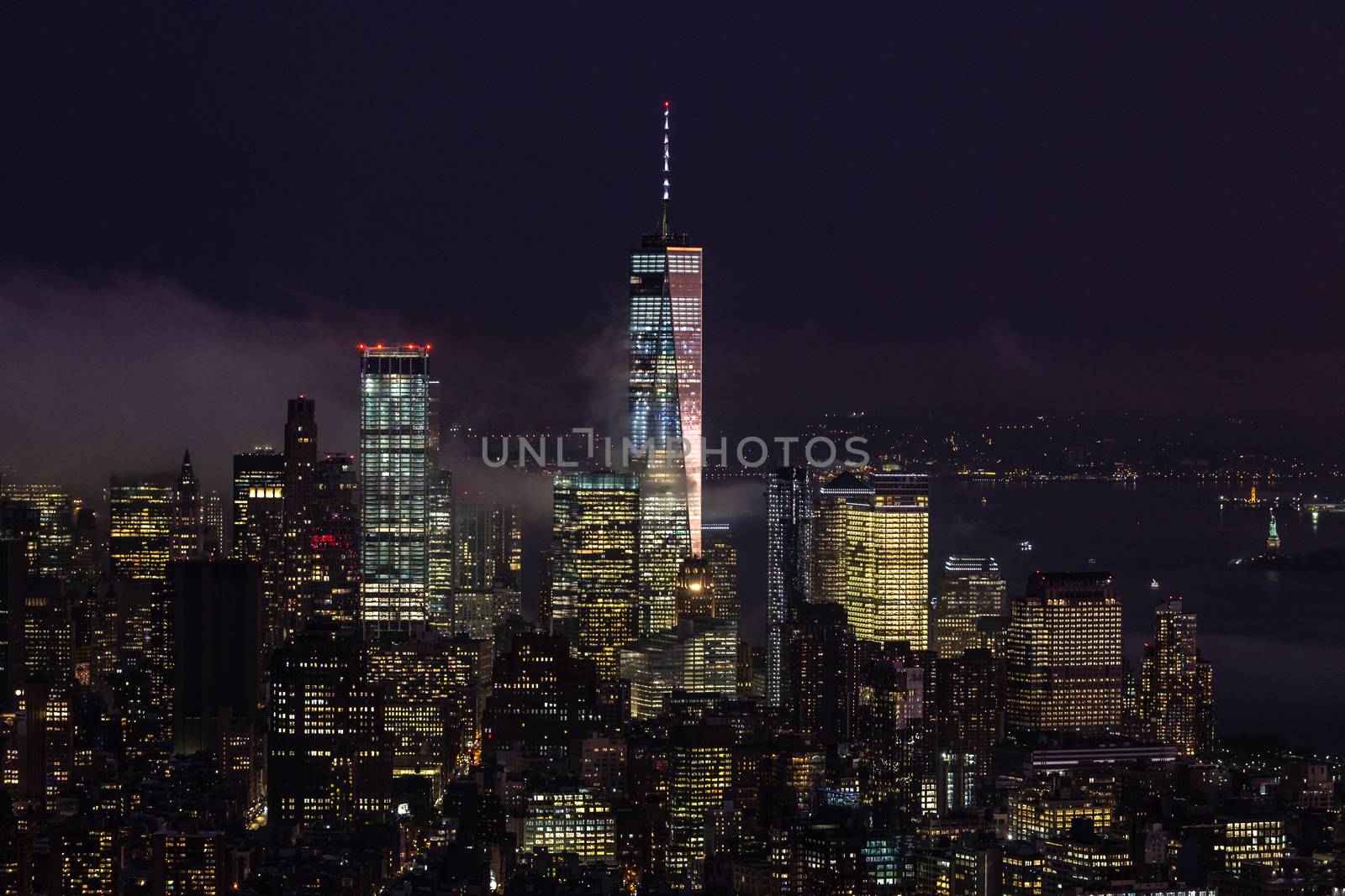 New York City skyline with lower Manhattan skyscrapers in storm at night. by kasto