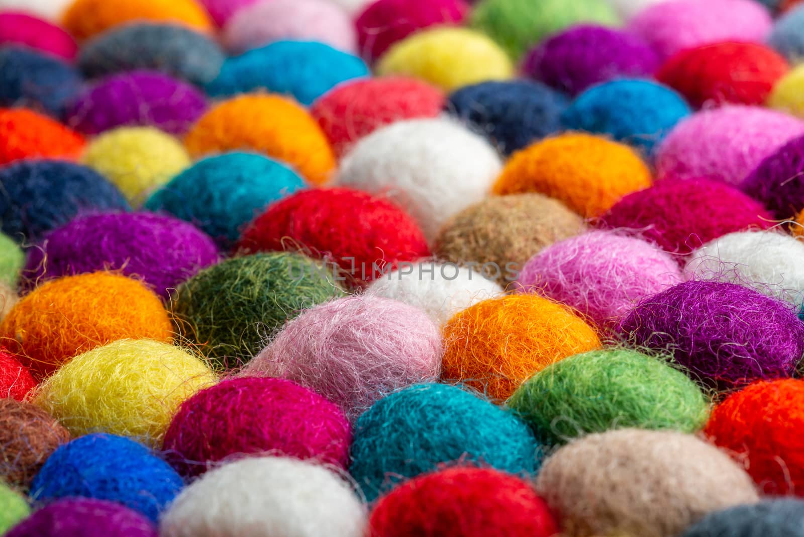 Multicolored felt ball rug detail, colorful texture