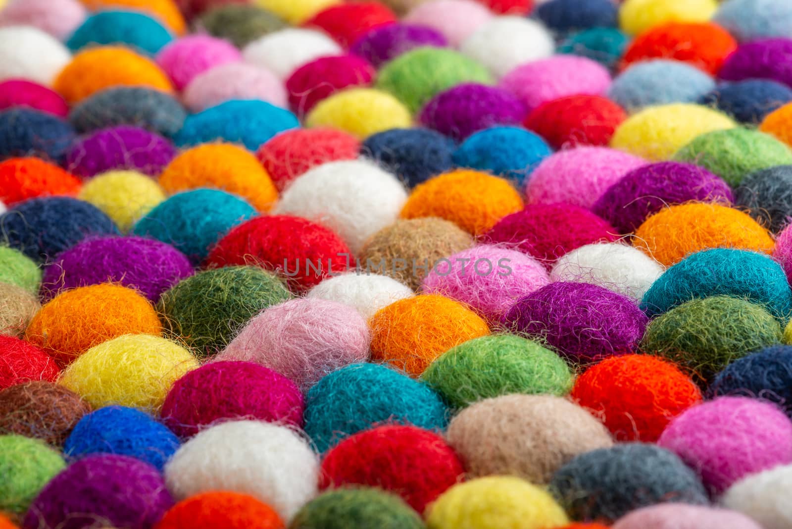 Multicolored felt ball rug detail, colorful texture