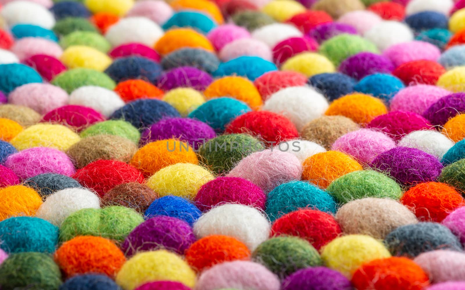 Multicolored felt ball rug detail, colorful texture