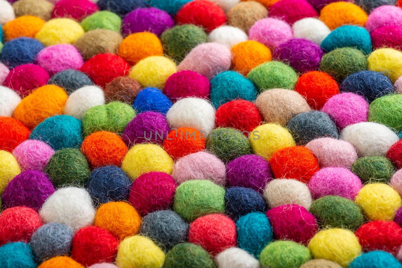 Multicolored felt ball rug detail by dutourdumonde