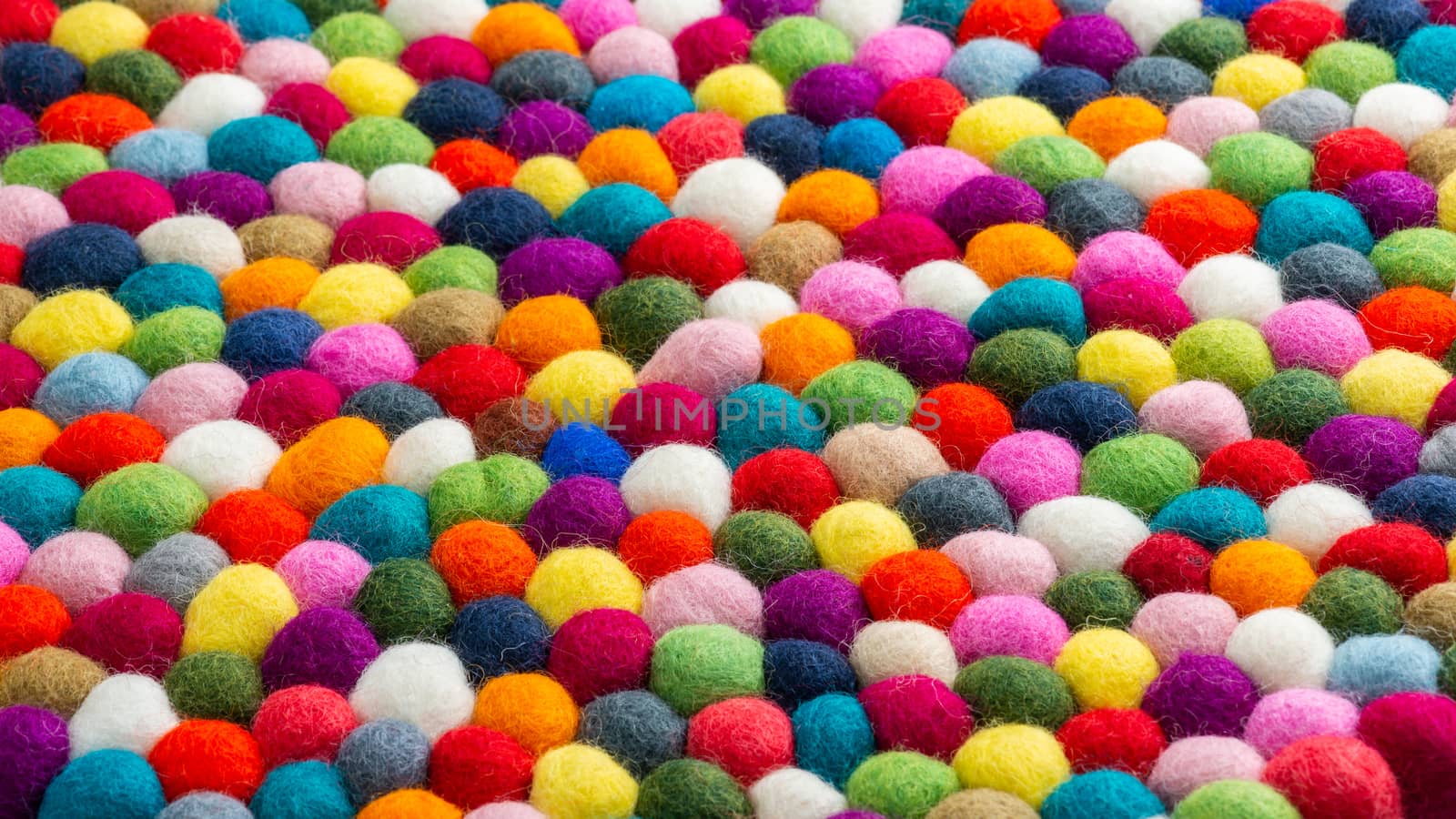 Multicolored felt ball rug detail by dutourdumonde